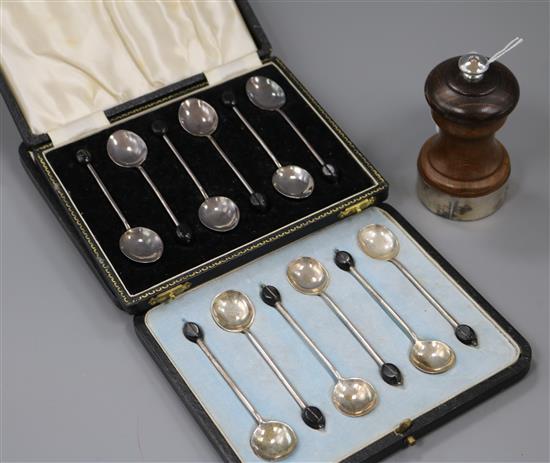 Two cased sets of silver bean end coffee spoons including enamel and a modern silver mounted pepper mill.